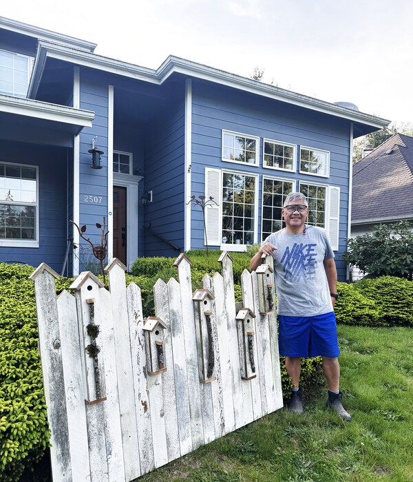 Mariano Ortiz with his fence panel birdhouse display