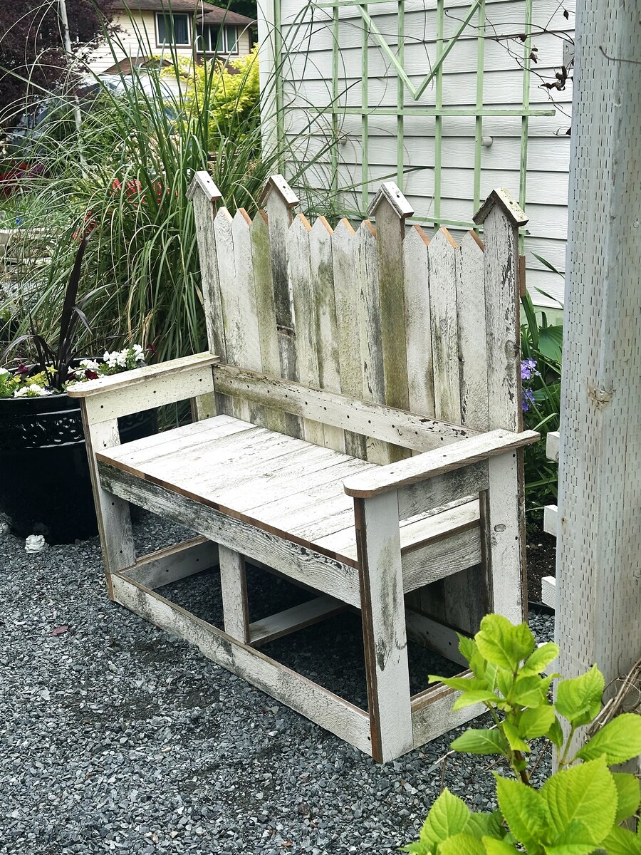 Whitewashed picket bench in garden