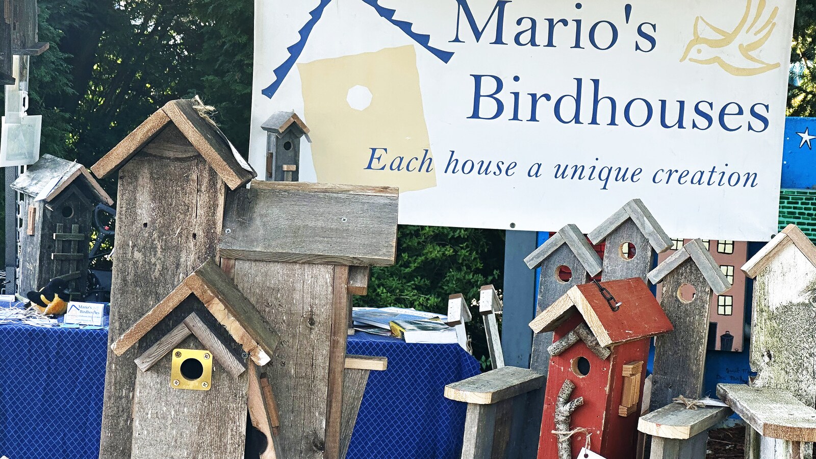 Mario's Birdhouses market display with sign